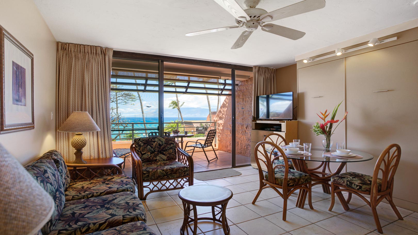 A spacious living room with access to the balcony  at VRI's Kuleana Club in Maui, Hawaii.